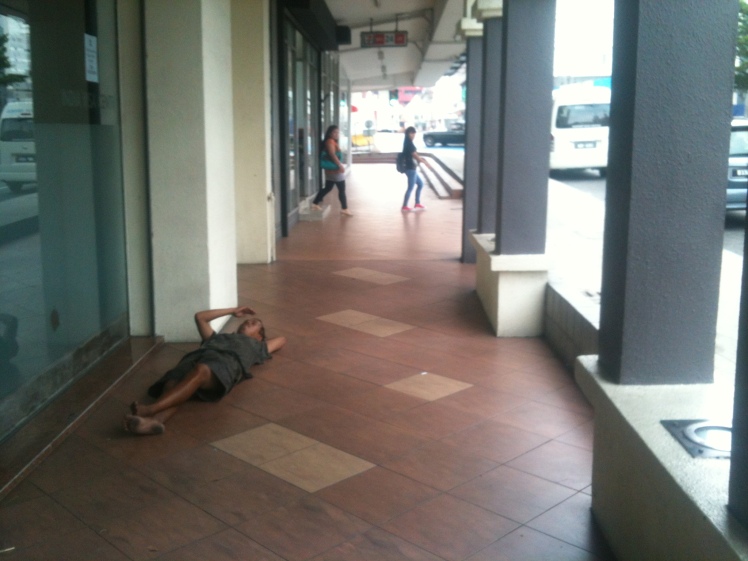 Homeless guy taking a nap in broad daylight. Speaks volumes of the state of the country it's in.